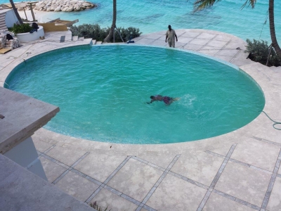 Pool coping and tiles with silver travertine accent strips. Pool coping and tiles with silver travertine accent strips.
