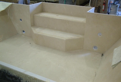 Constructing a custom crema marfil marble spa. Constructing a custom crema marfil marble spa.